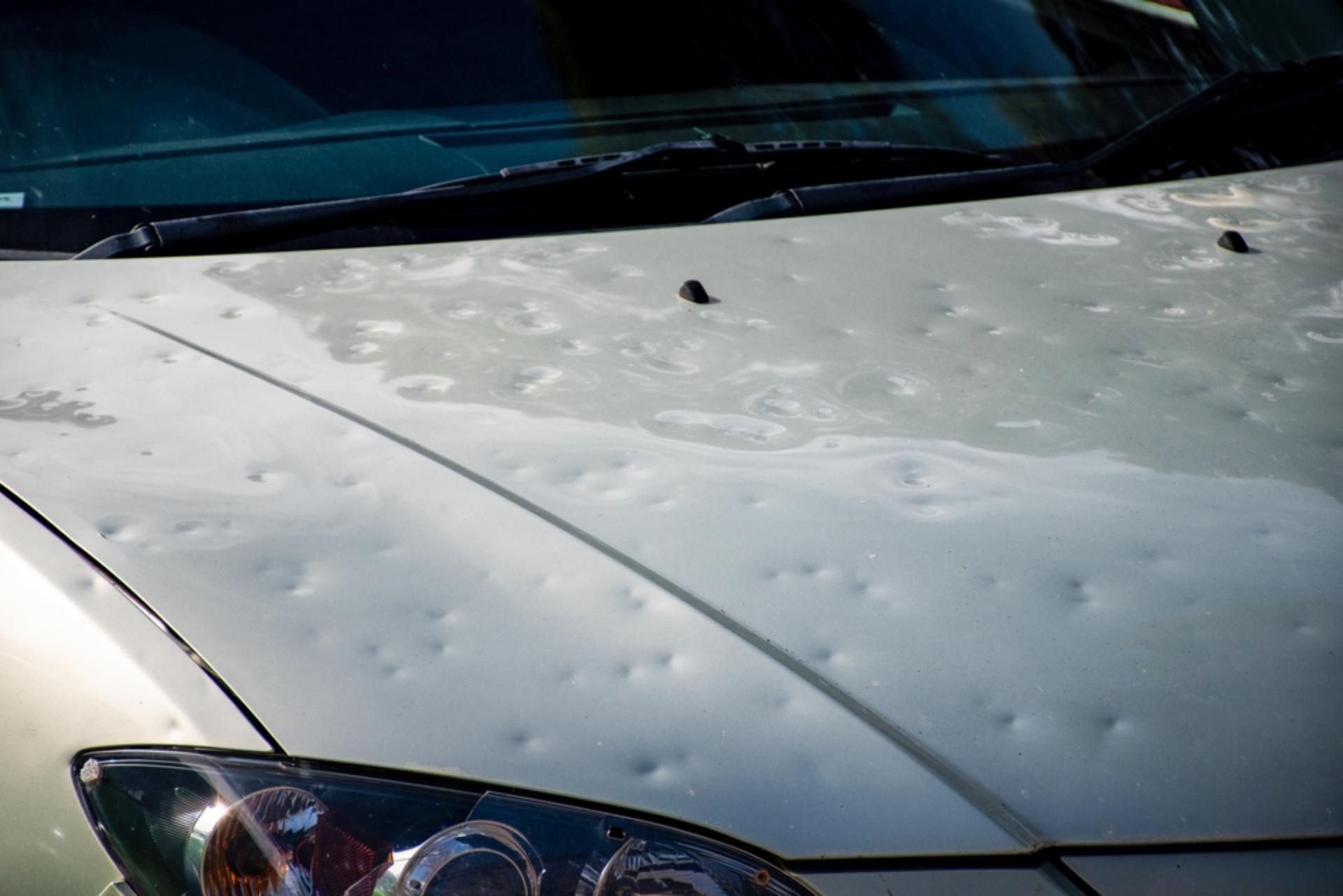 severe hail damage on the hood of a vehicle